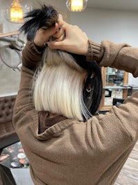 a woman is putting her hair up in a salon