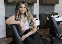 a woman sitting in a chair in a salon